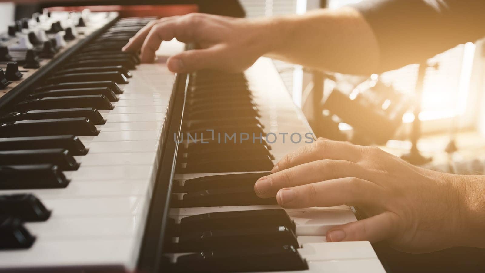 Man hands playing pia no keyboard with passion. Musician perfomance with classical music indoors on pianoforte