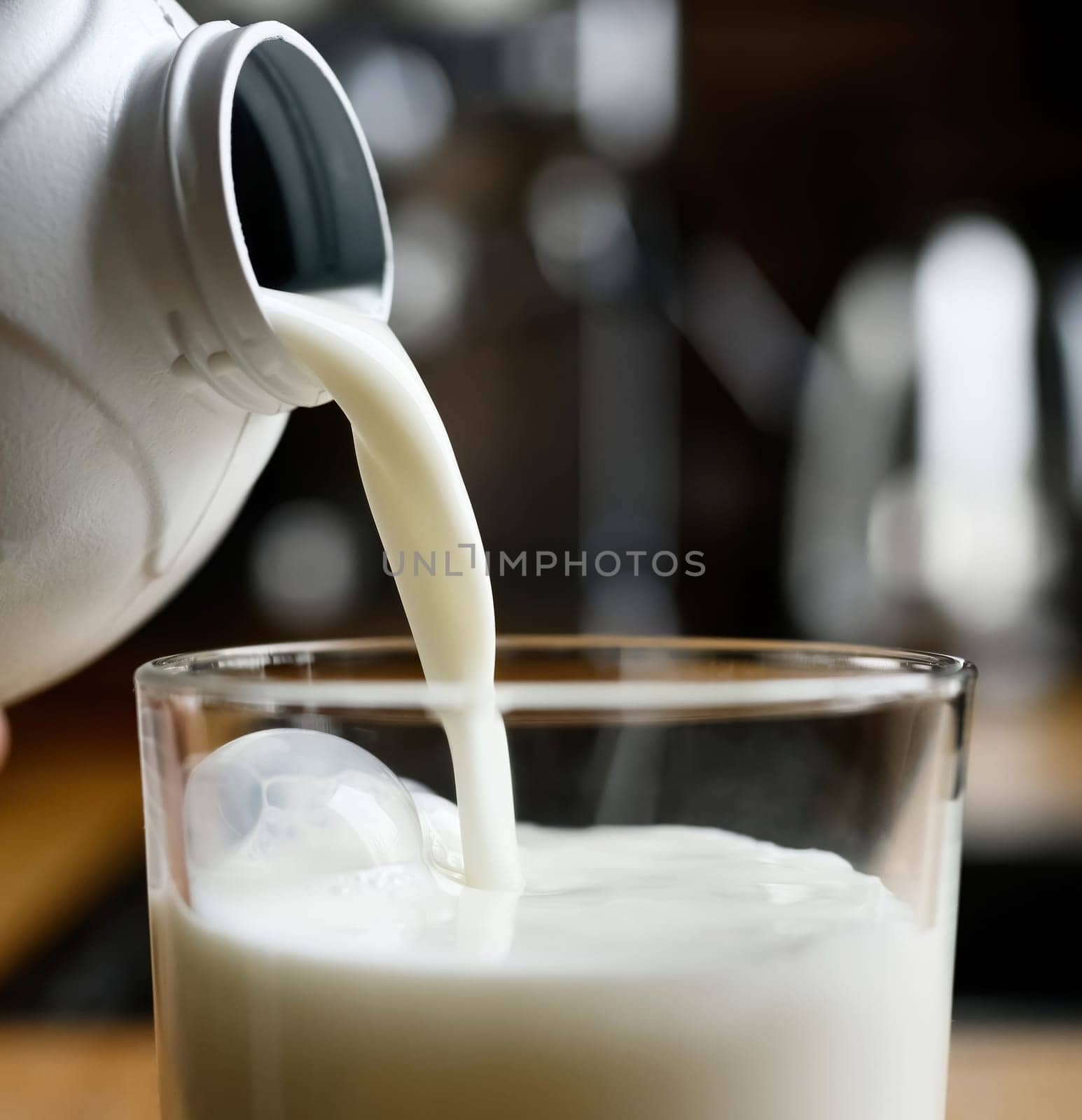 Pouring milk in glass, close up