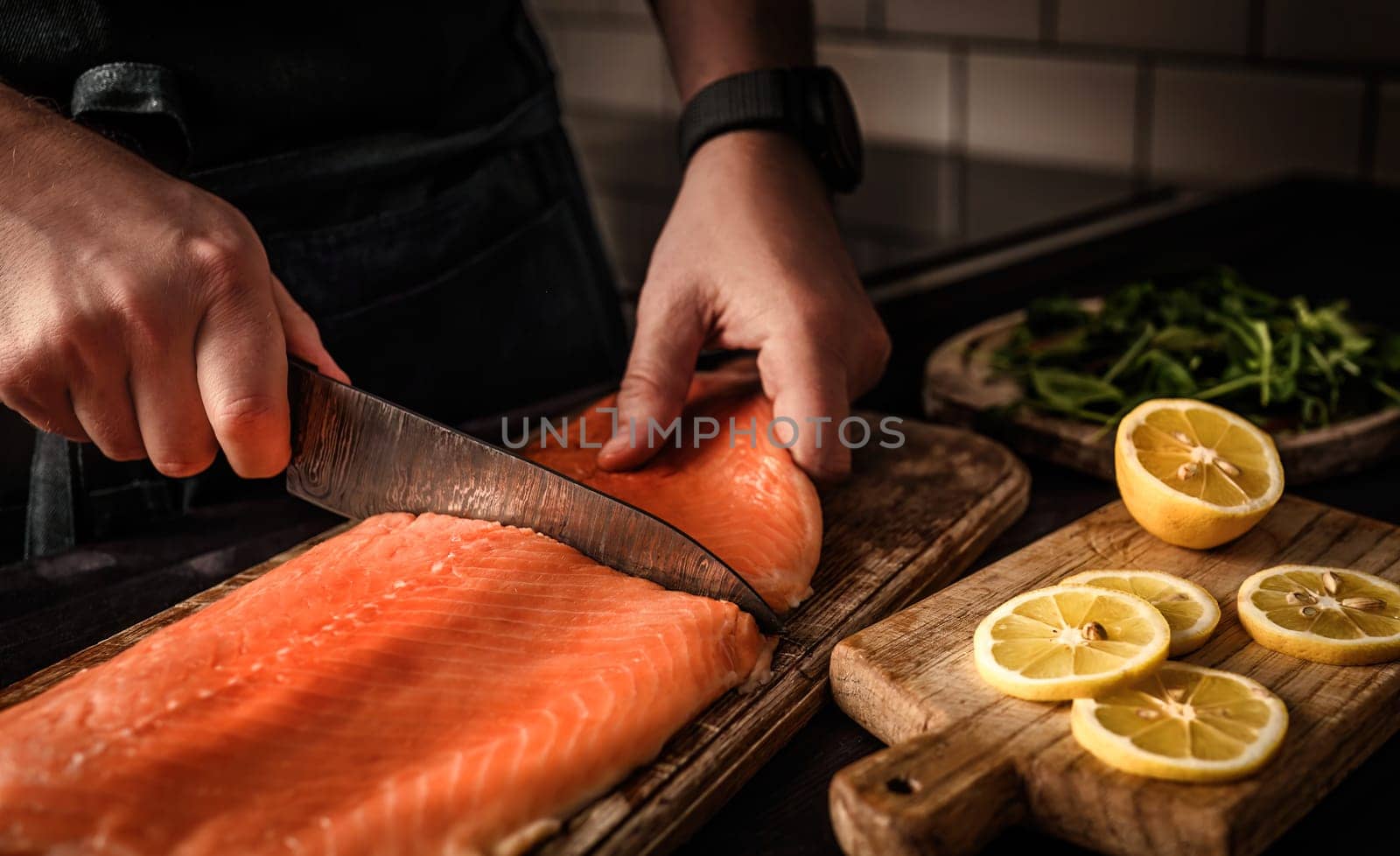 chief cutting salmon red fish in the kitchen by GekaSkr
