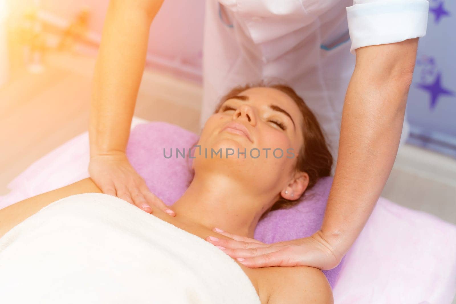 Facial massage. A woman is given a massage in a beauty salon. Close-up.