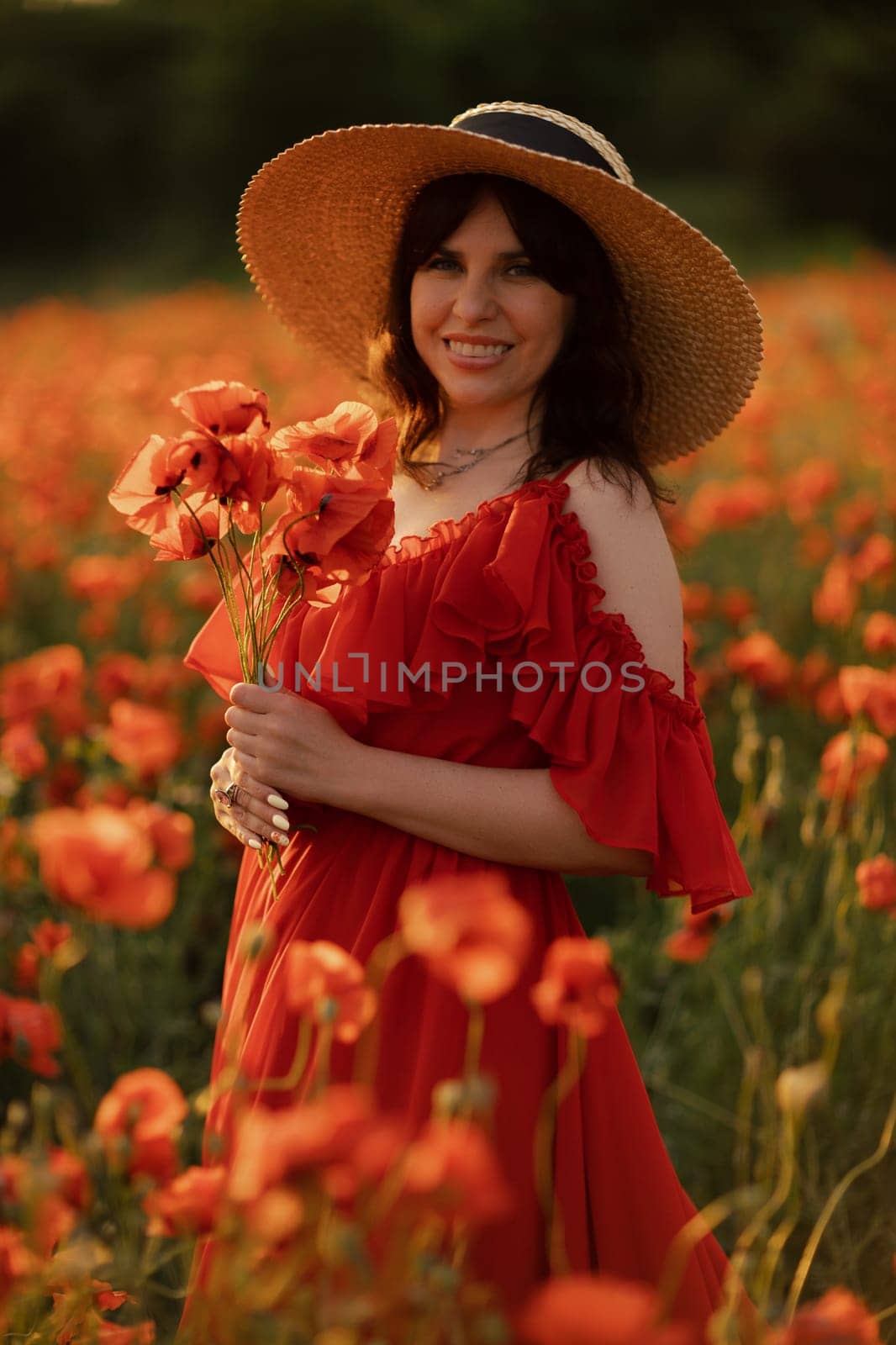 Woman poppy field red dress hat. Happy woman in a long red dress in a beautiful large poppy field. Blond stands with her back posing on a large field of red poppies. by Matiunina