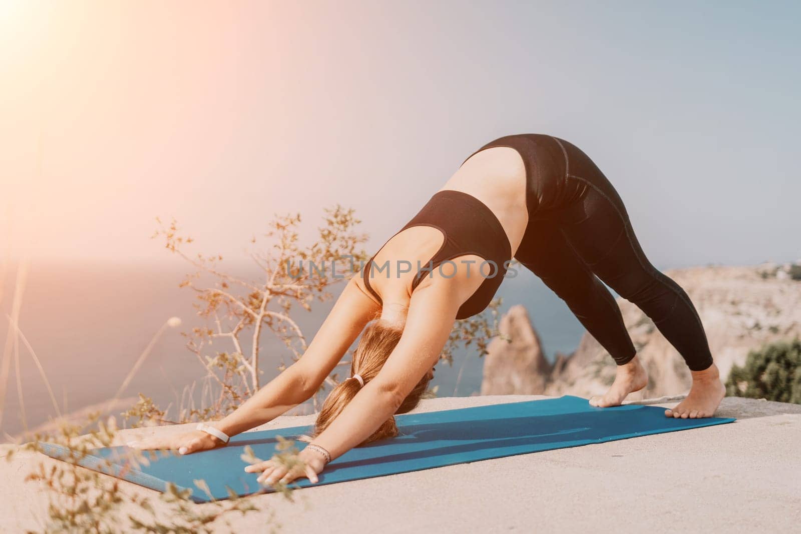 Fitness woman sea. Outdoor workout on yoga mat roller in park near to ocean beach. Female fitness pilates yoga routine concept. Healthy lifestyle. Happy fit woman exercising with rubber band in park. by panophotograph