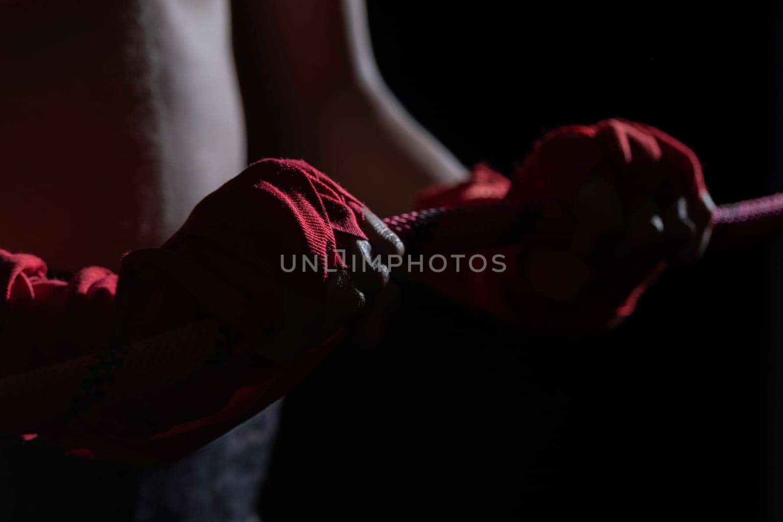 A tightly clenched hand on the boxing ring. A player strongly focused before her life fight .