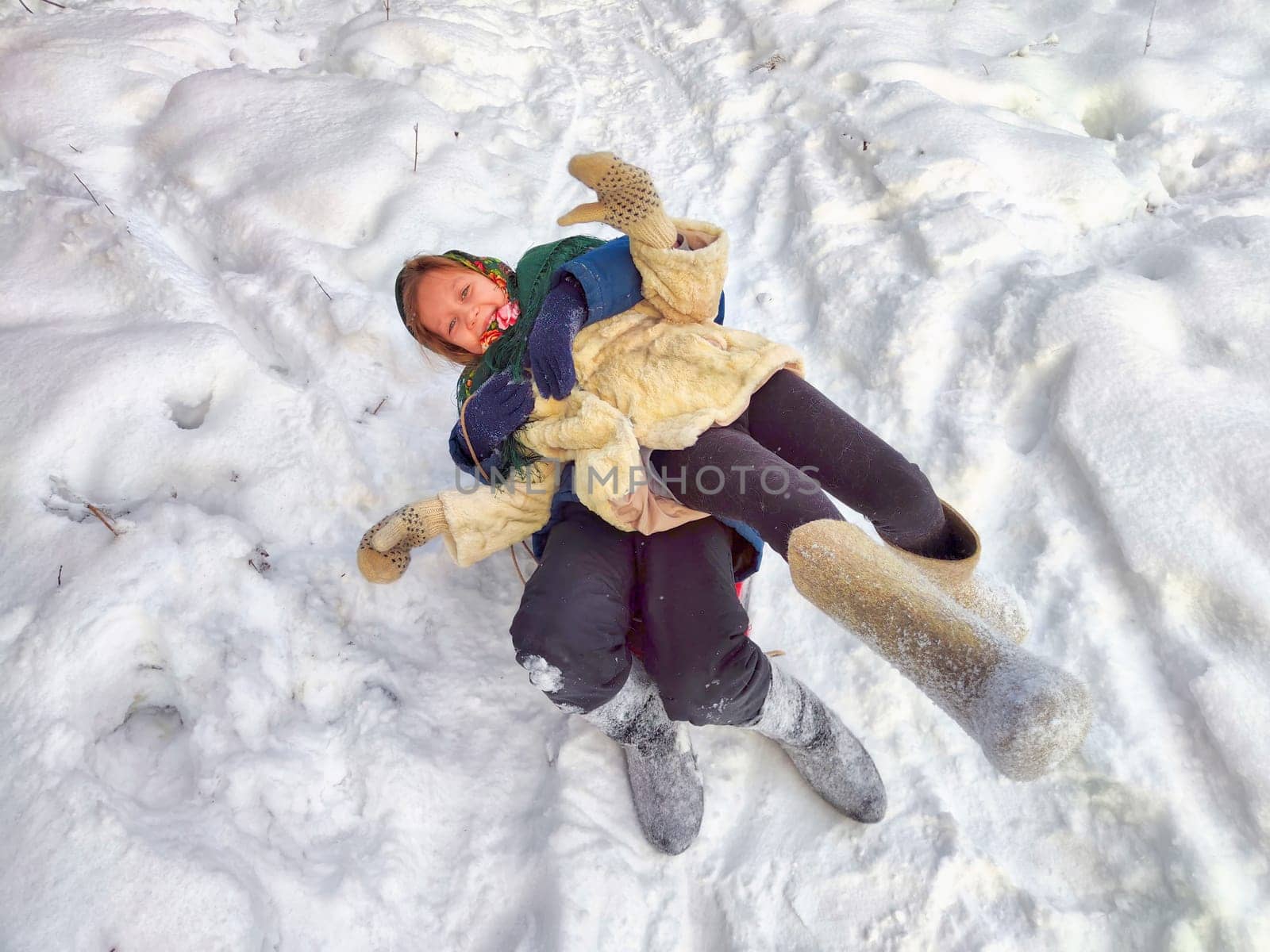 Two cute happy little cheerful children having fun in winter snow forest. Photo shoot in stylized clothes of USSR. Fur Hat with earflaps by keleny