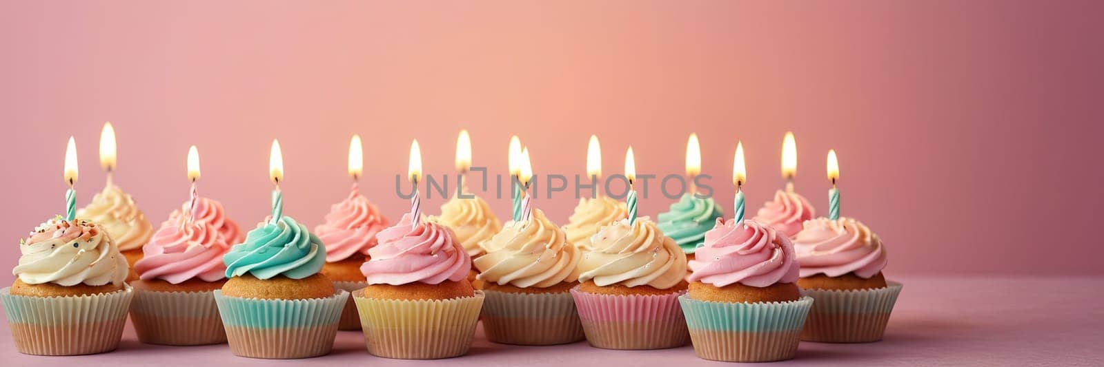 Colorful cupcakes with lit candles are displayed against a pink background, indicating an indoor celebration event marking of joy and celebrating. with free space by Matiunina