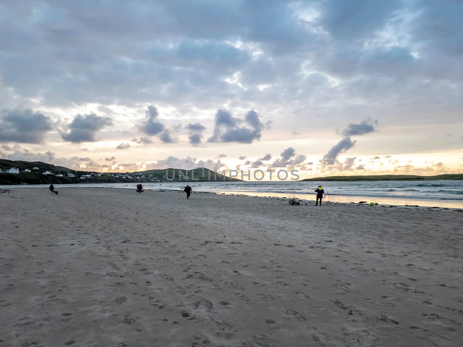 20 man are competing in a fishing competition on the beach