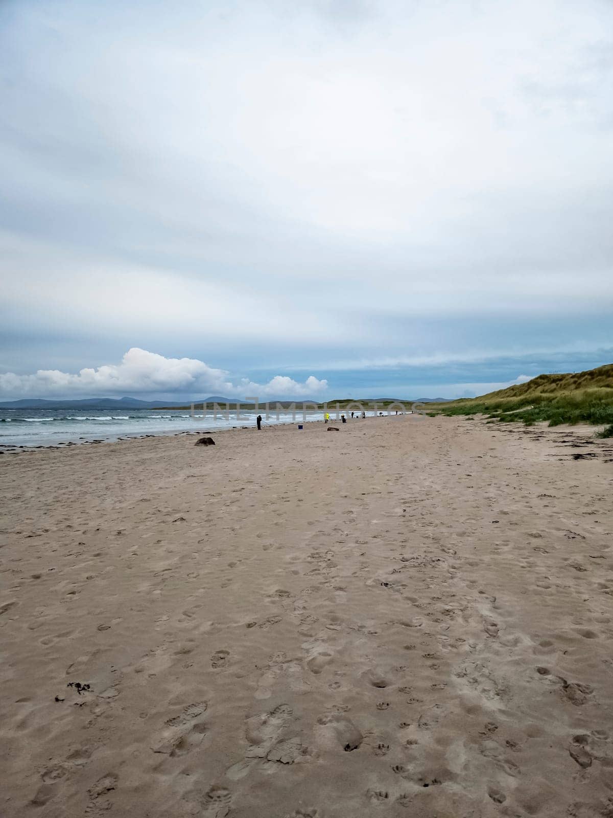 20 man are competing in a fishing competition on the beach