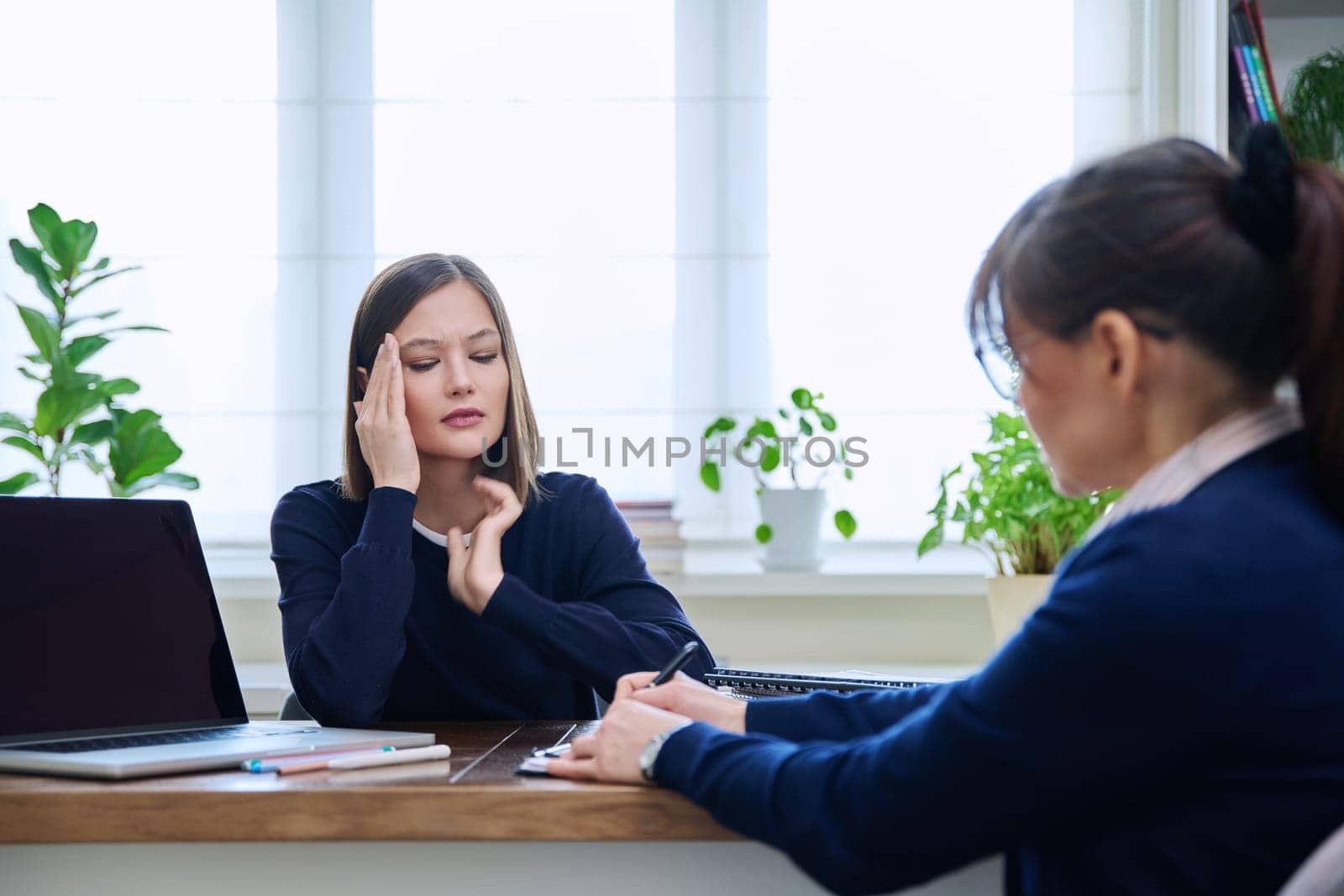 Sad unhappy young woman patient at session with female psychologist therapist social worker counselor psychotherapist. Mental health professional support treatment, feelings stress depression trauma