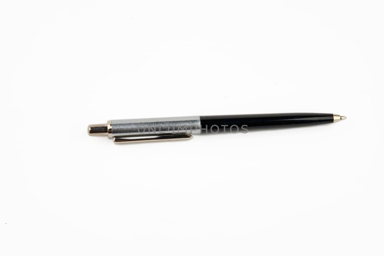 A pen highlighted on a white background with a ballpoint tip