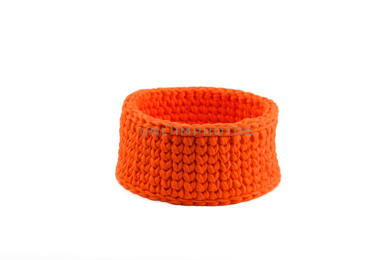 Wicker orange basket on a white background