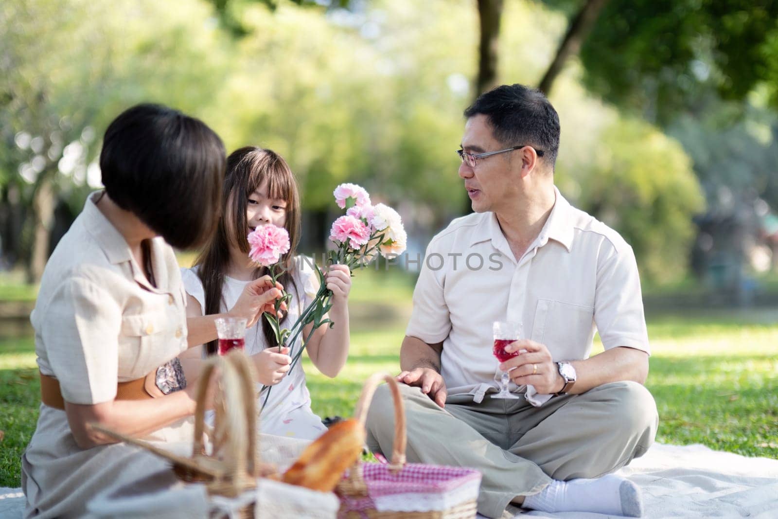 Grandparents enjoying with granddaughter in park and serenity. They are having joyful and cheerful time together. Loads of smile and happy moment by nateemee