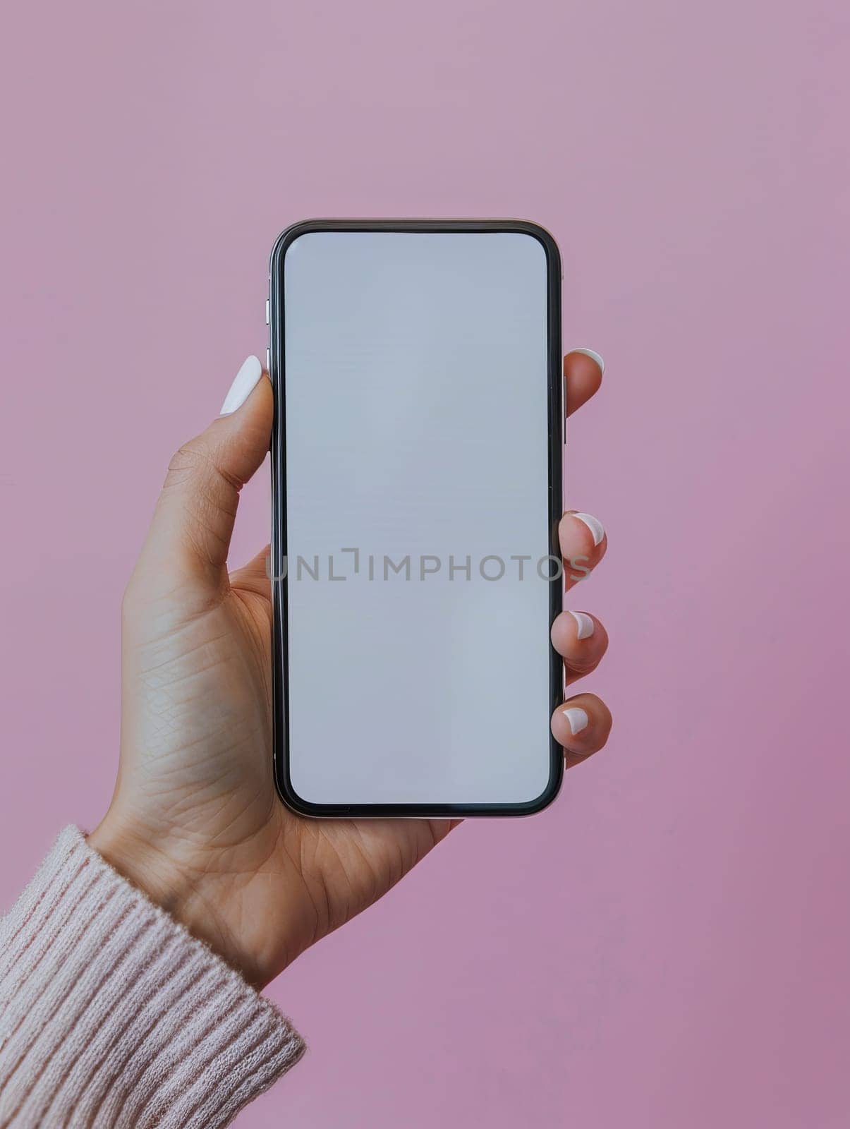 A person is holding a phone with a white screen. The phone is in a pink background