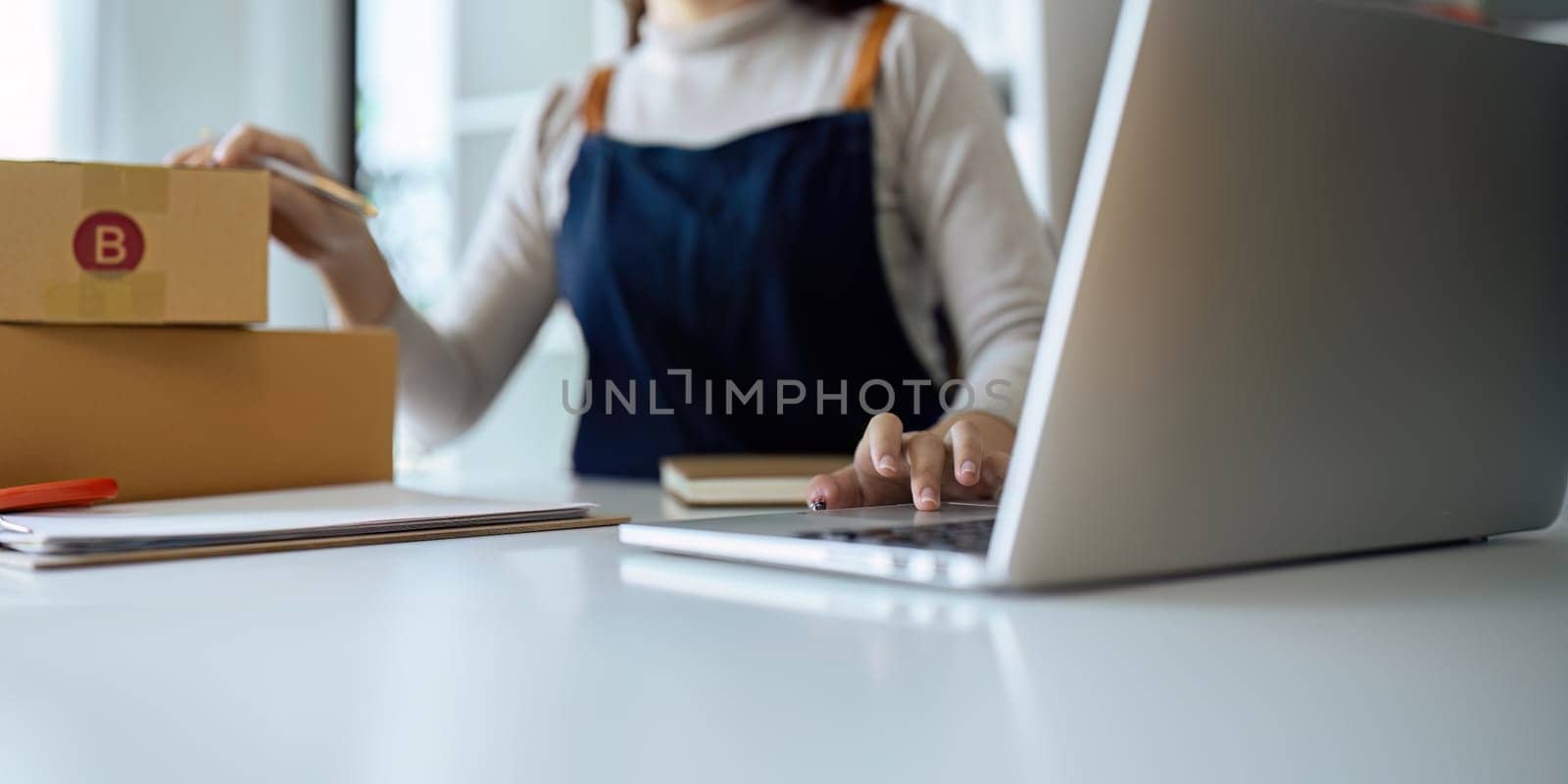 Startup small business owner working with laptop at workplace. Online selling. Ecommerce. Online Shopping.