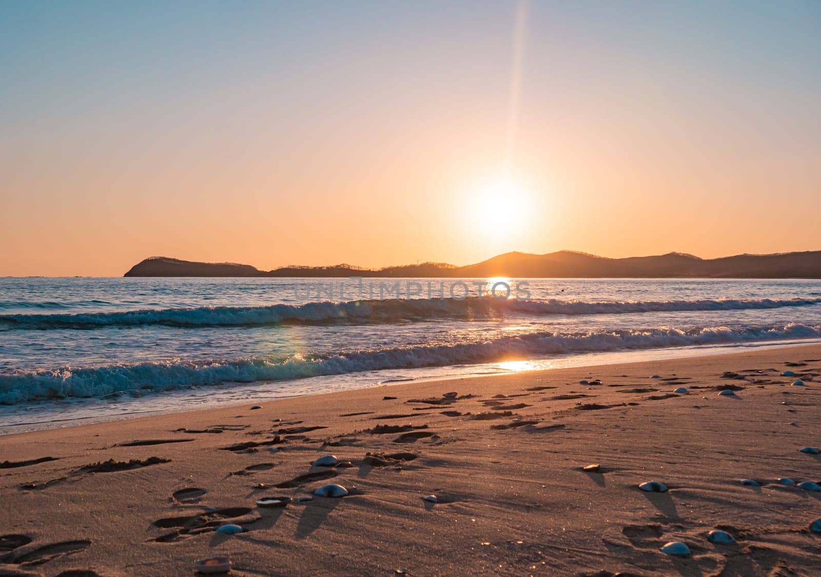 Sunset on the beach. Orange and golden sunset sky calmness tranquil relaxing sunlight summer mood. by Busker