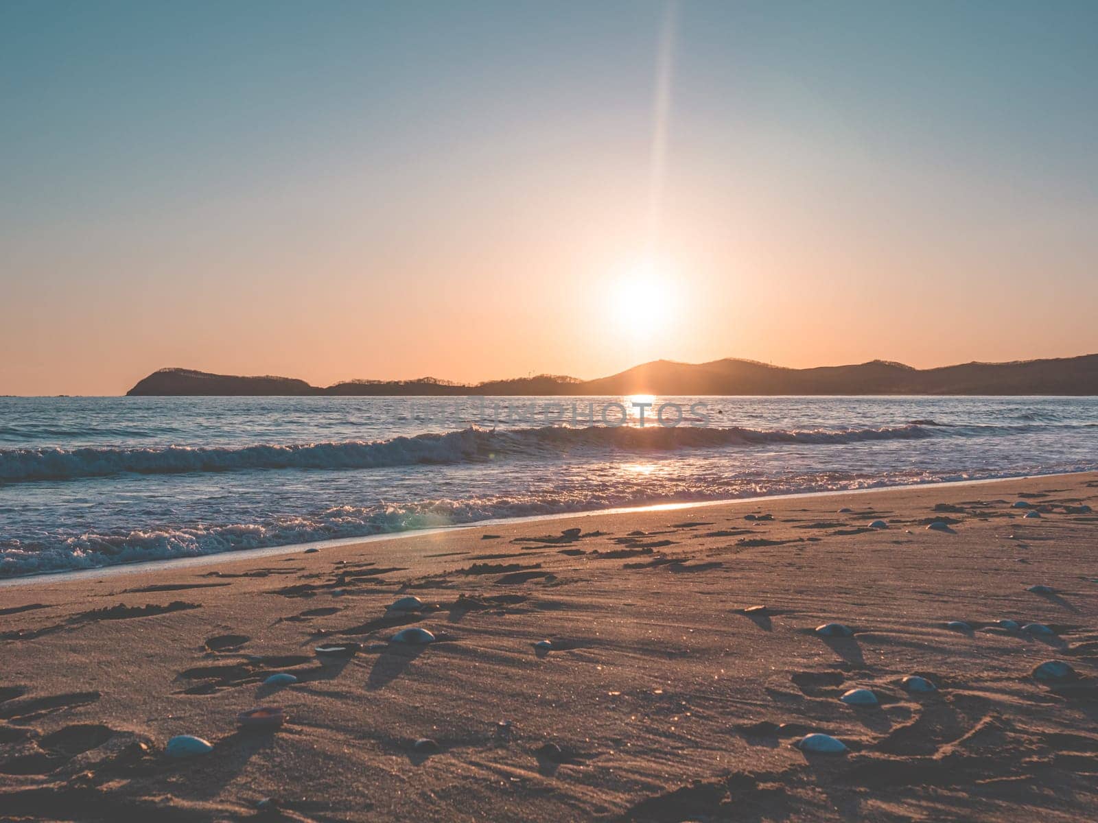 Sunset on the beach. Orange and golden sunset sky calmness tranquil relaxing sunlight summer mood. by Busker