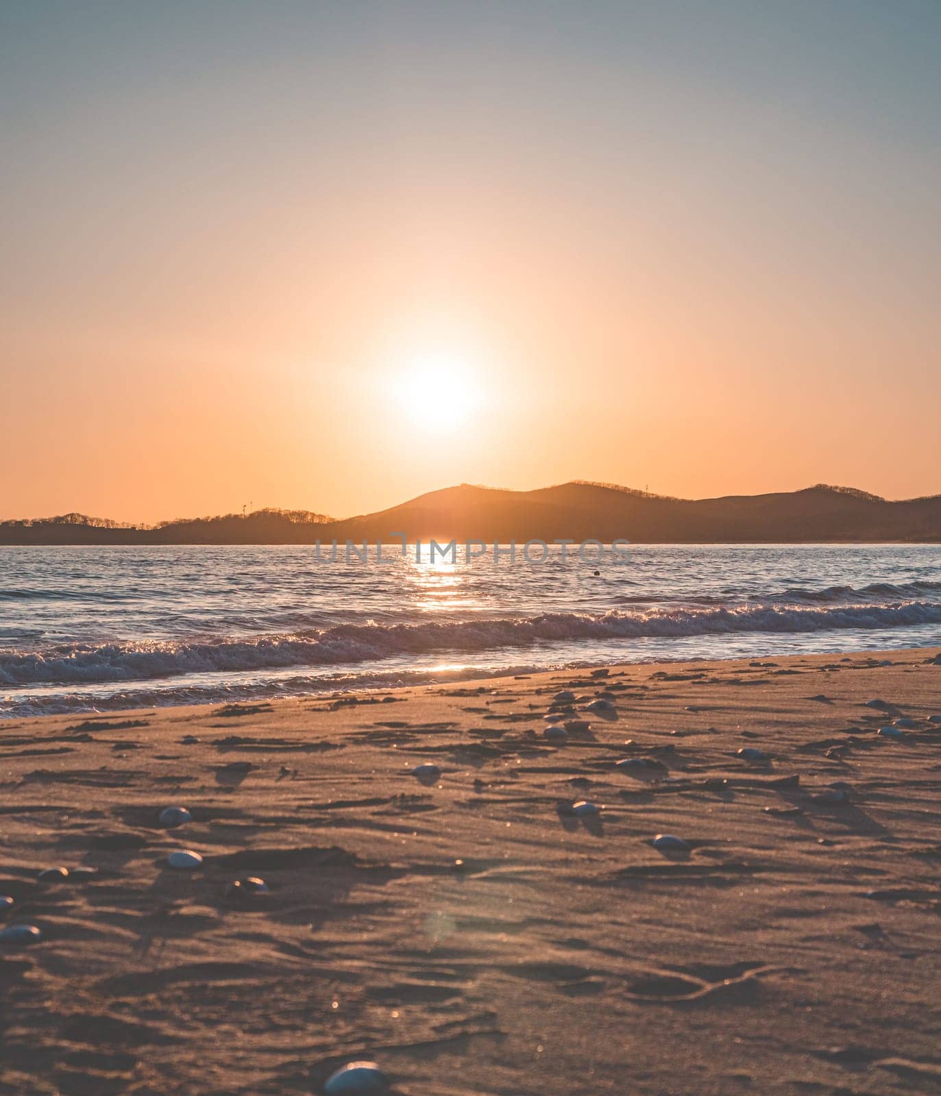 Sunset on the beach. Orange and golden sunset sky calmness tranquil relaxing sunlight summer mood.