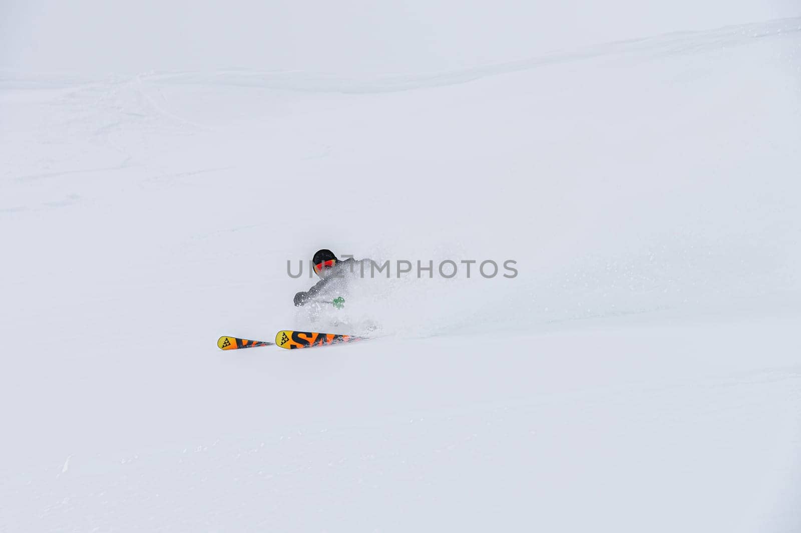 Male skier turns in loose snow, skier downhill downhill at ski resort by yanik88