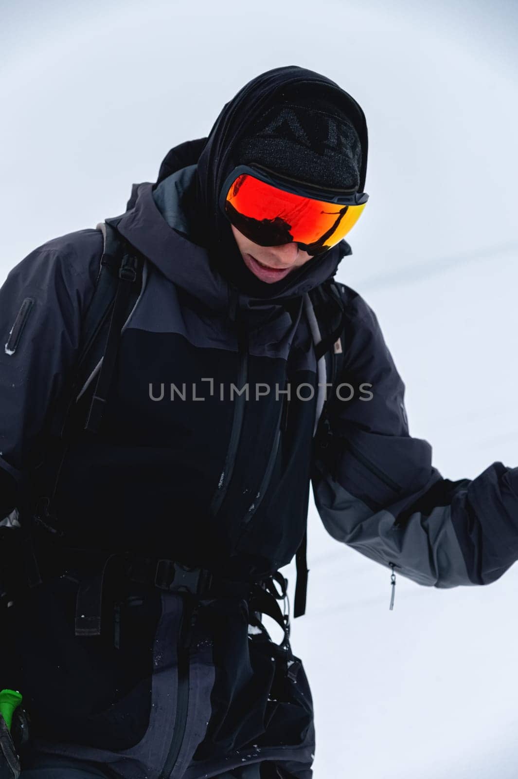 Portrait of a skier in safe ski equipment, standing and relaxing smiling while on vacation on the ski slope.