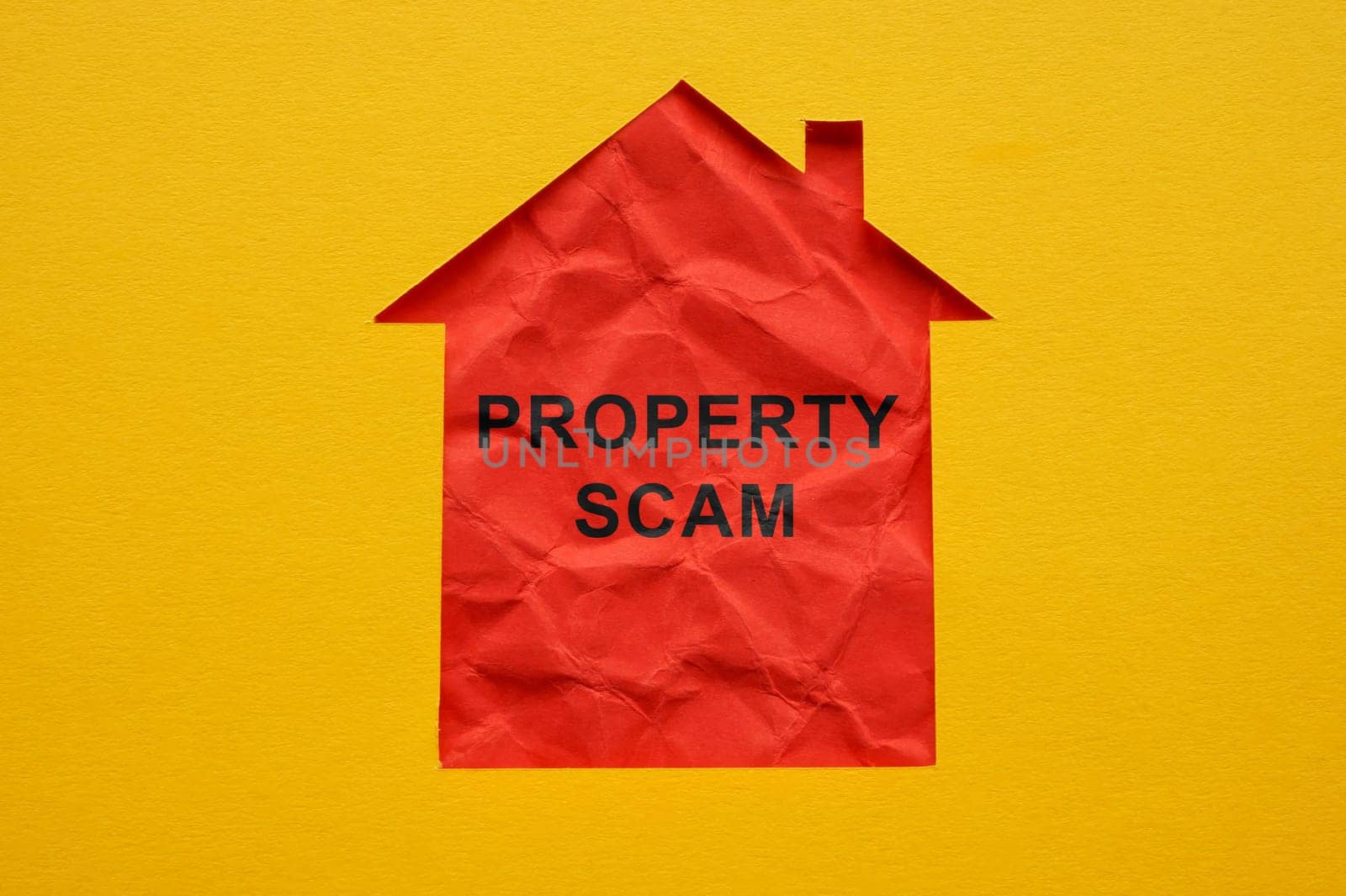 Property scam concept. Outline of house cut out in paper.