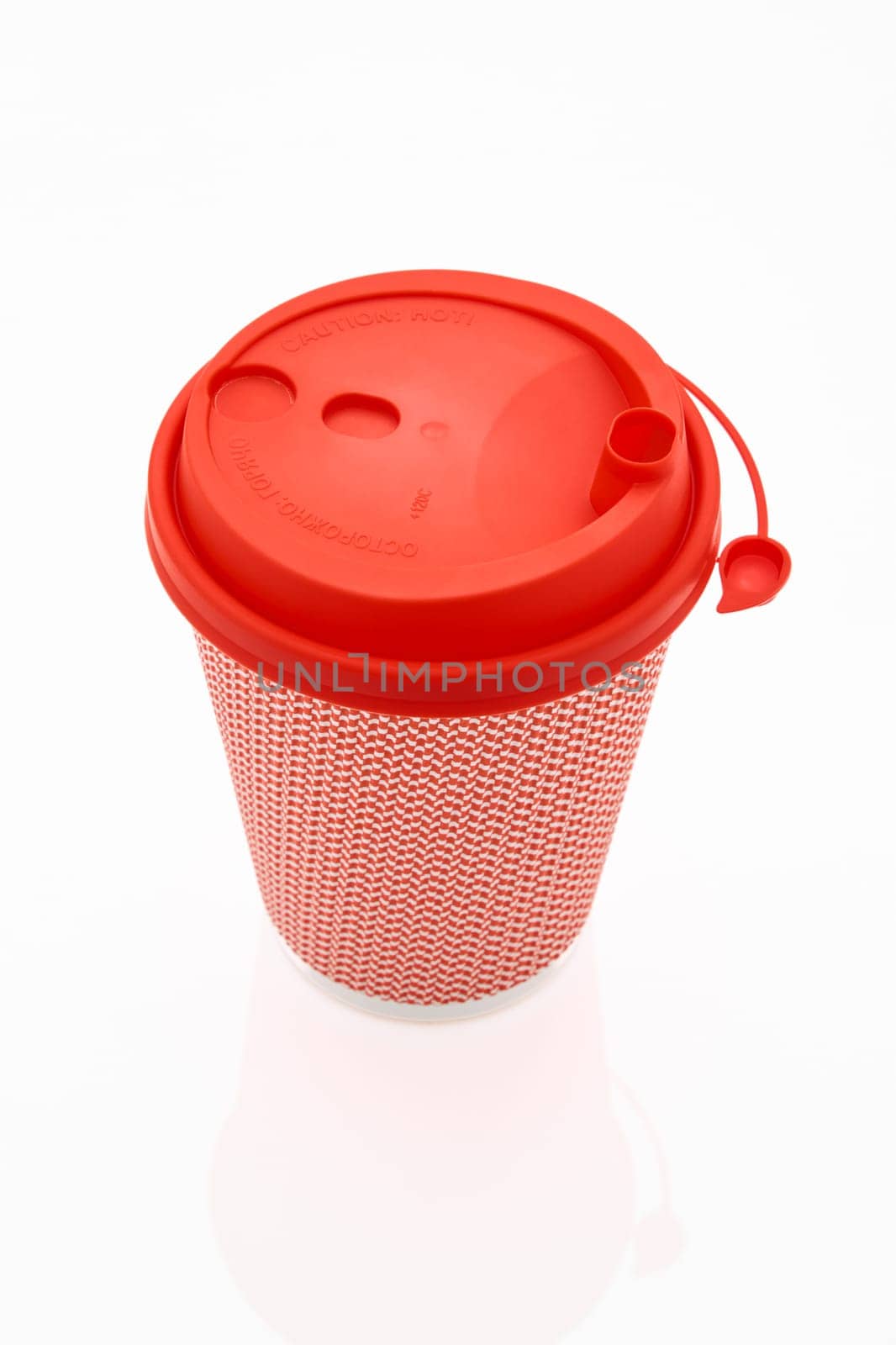 The pink cardboard coffee cup with a red plastic lid on the white glossy background, the inscription on the lid is Carefully Hot, transparent background. High quality photo