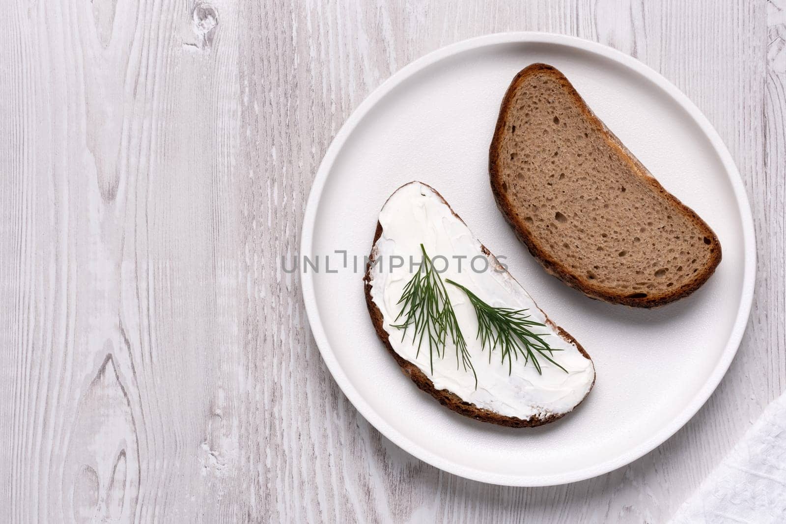 Sandwiches with soft curd cheese on a white wooden table by NataliPopova