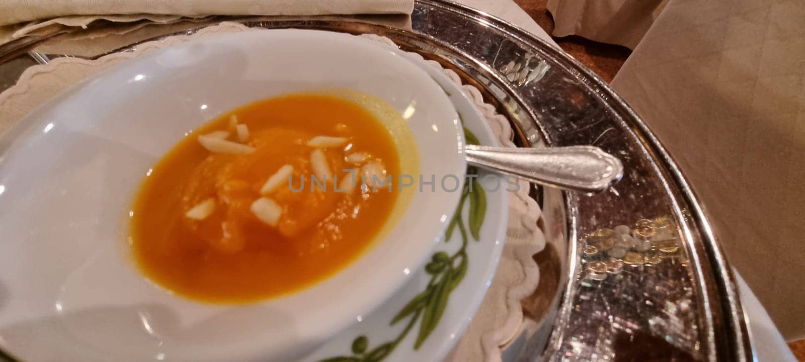 Close-up of a delicious pumpkin soup garnished with almonds, ready to be served