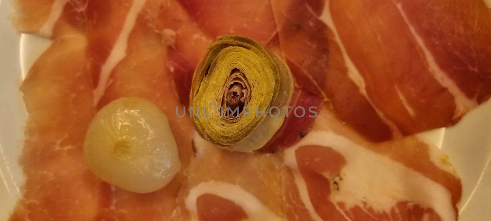 Gourmet cured meat and artichoke platter close-up by FlightVideo