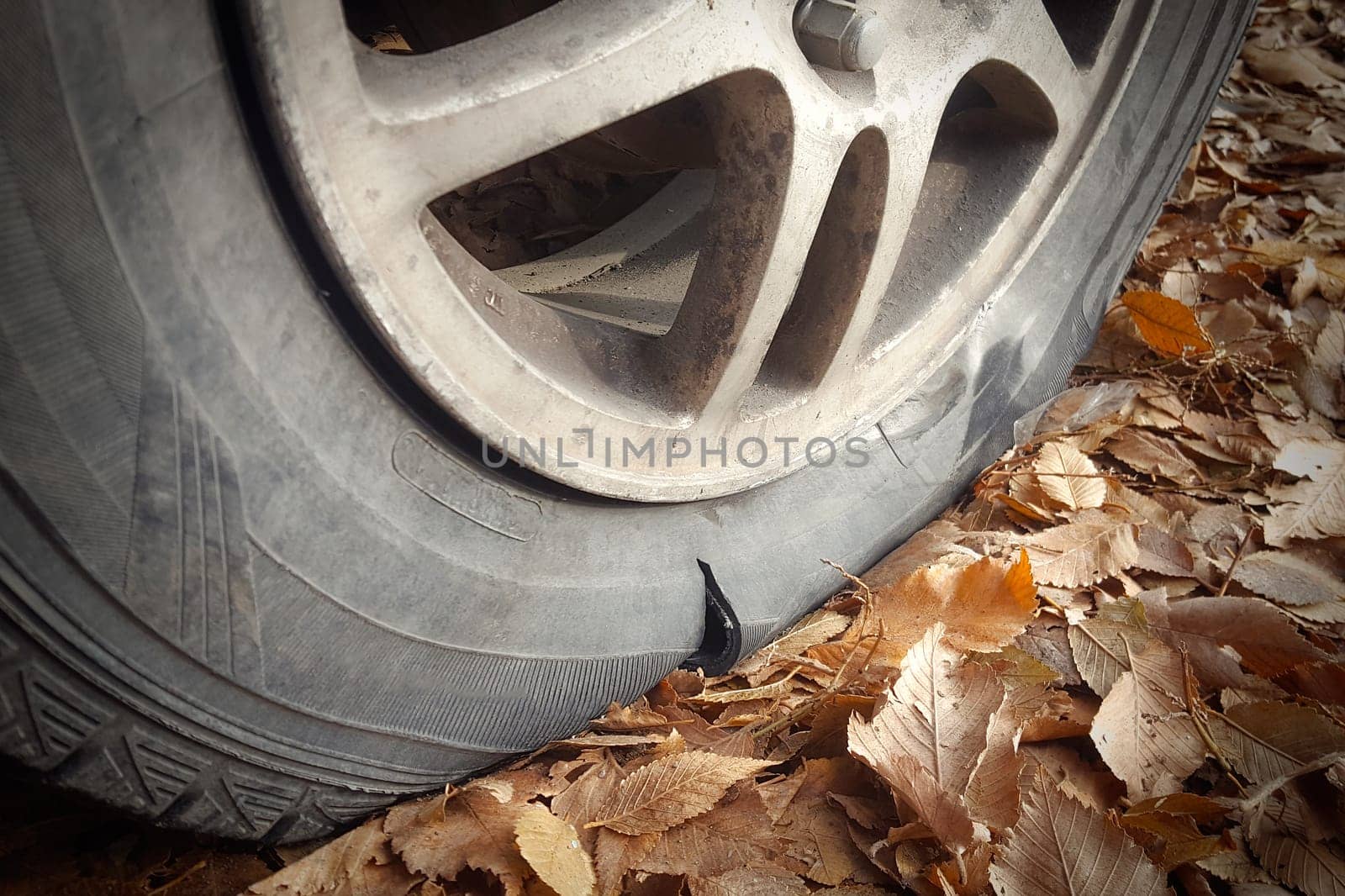 Close-up of a car wheel with a torn tire on the side by Rom4ek