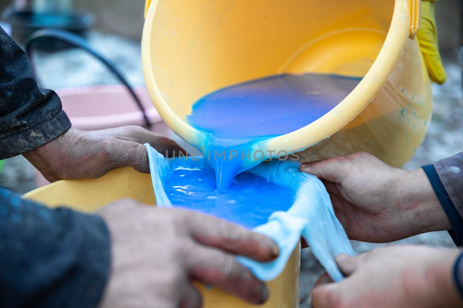 Preparation and straining of Bordeaux liquid for seasonal treatment of trees in the garden by spraying.