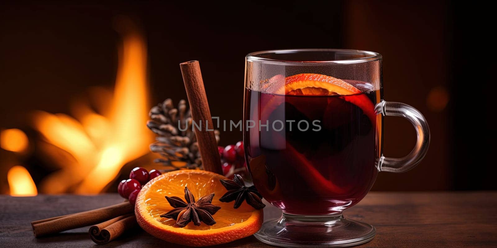 Hot gluhwein in two glasses, mulled wine with oranges and spices against burning fireplace by GekaSkr