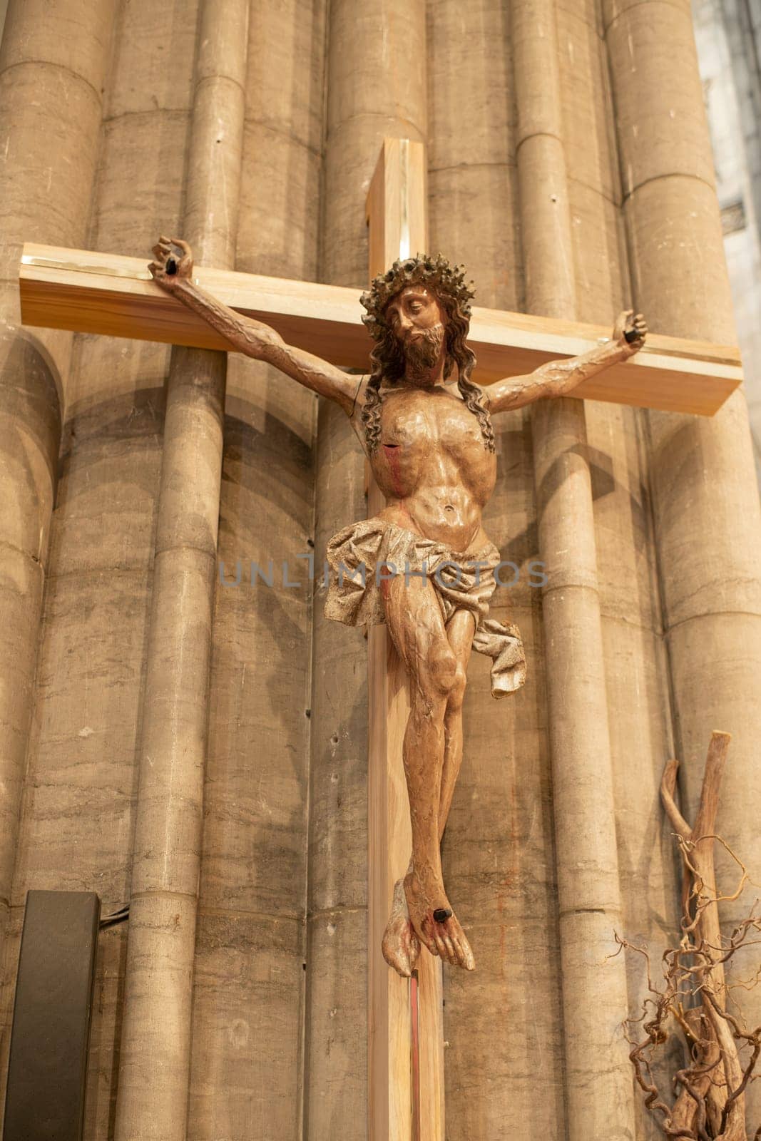 A statue of Jesus hanging from a cross by Godi