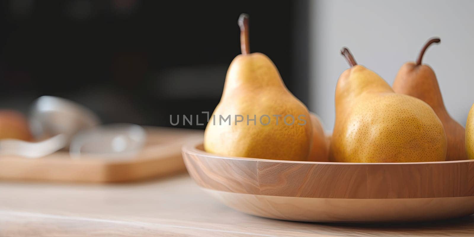 Pears in a bowl on the kitchen table on a blurred background by GekaSkr