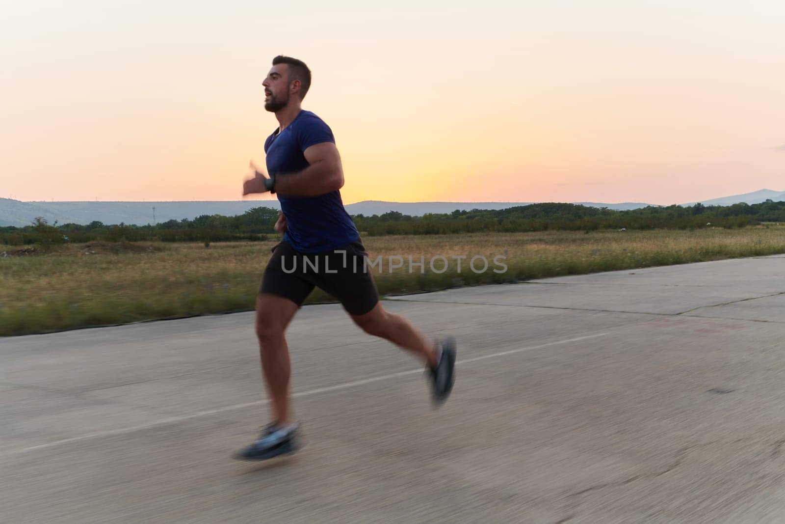 A highly motivated marathon runner displays unwavering determination as he trains relentlessly for his upcoming race, fueled by his burning desire to achieve his goals.