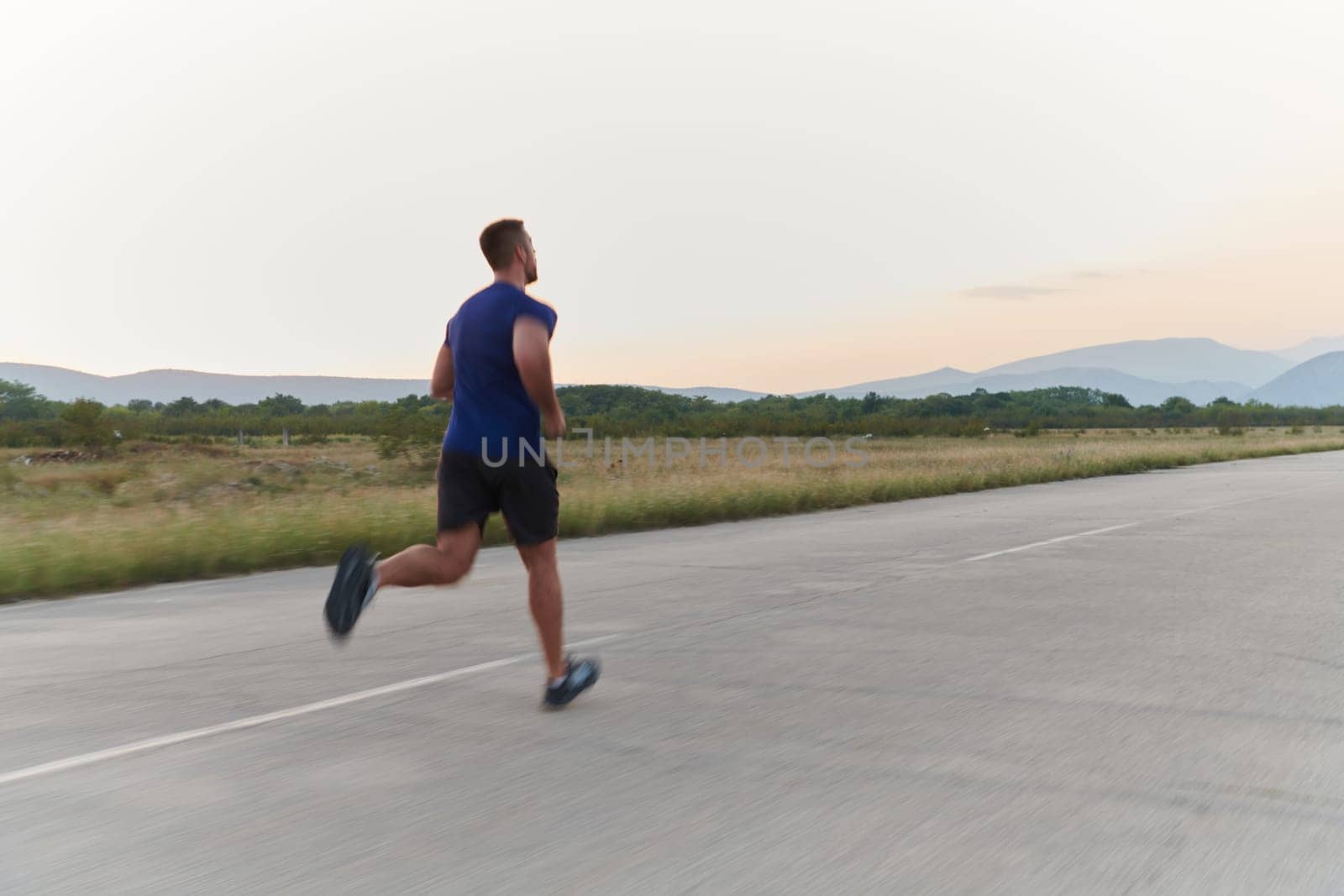 A highly motivated marathon runner displays unwavering determination as he trains relentlessly for his upcoming race, fueled by his burning desire to achieve his goals.