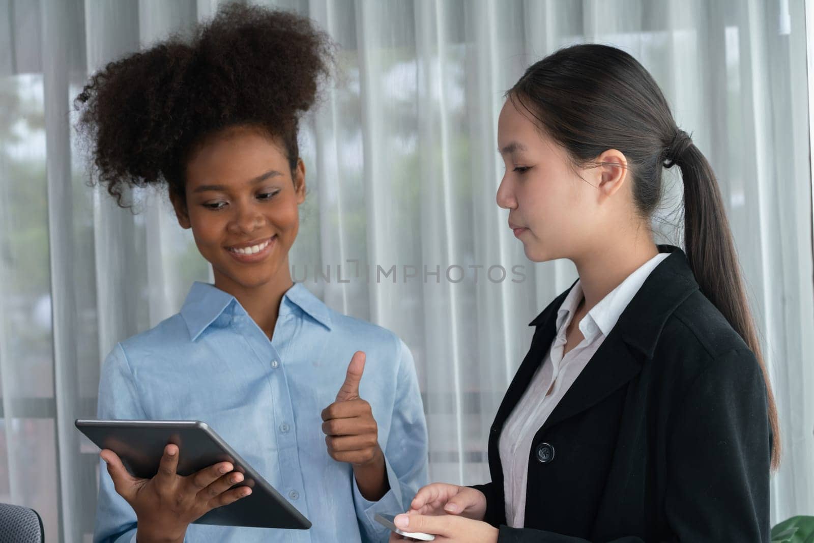 Happy diverse business people work together, discussing in corporate office with tablet. Professional and diversity teamwork discuss business plan. Modern multicultural office worker. Concord