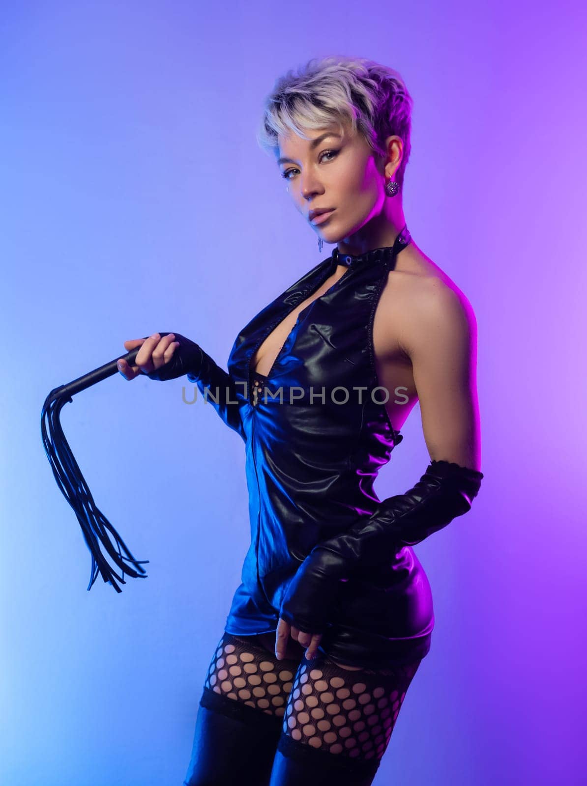 sexy girl in erotic bdsm image mistress in latex dress posing in front of a copy paste neon background by Rotozey