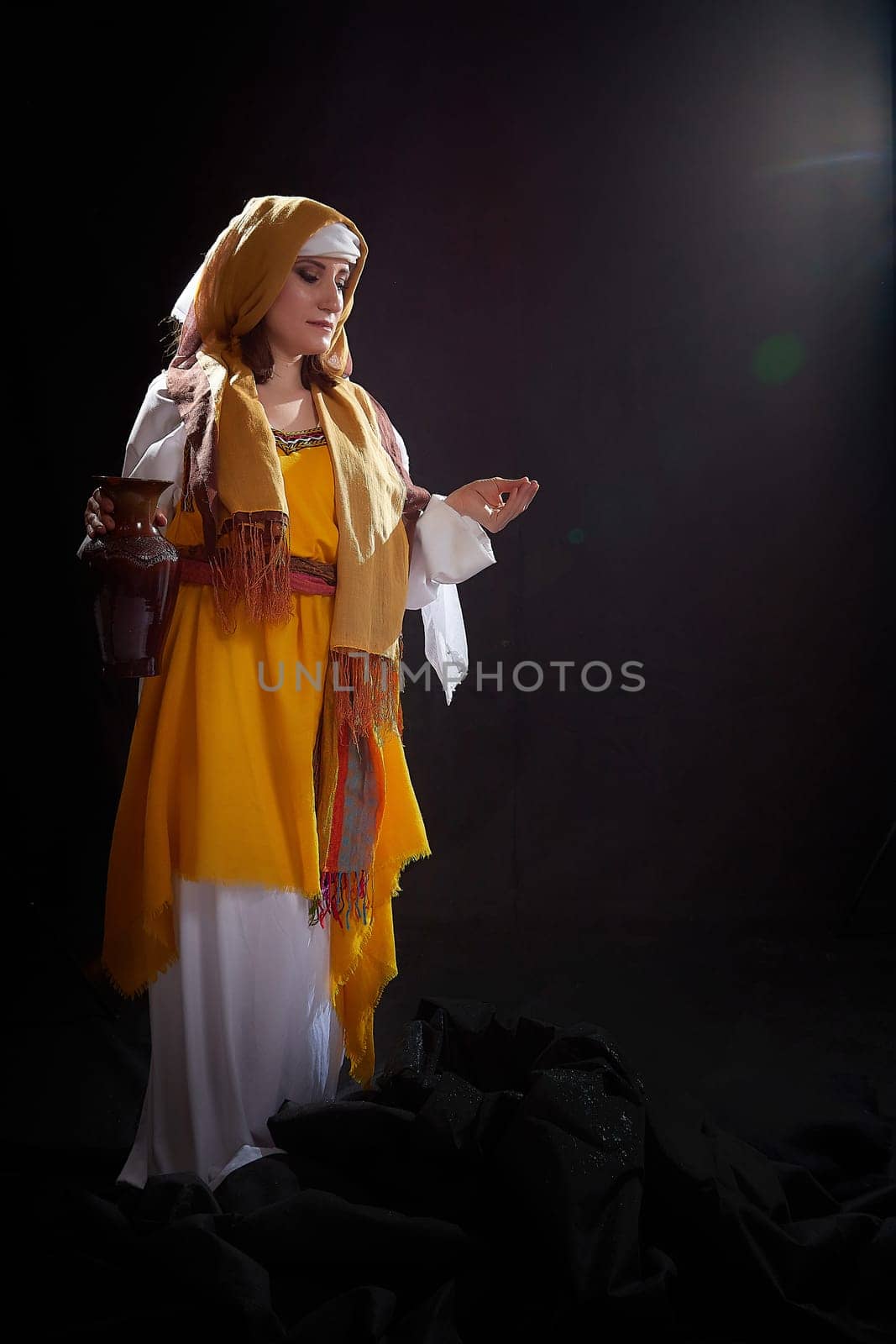 A girl or a young woman from ancient Israel, Palestine, Iran, Iraq with a clay jug. A biblical story with Rebekah and water. Stylized photo shoot with a model in Middle Eastern clothes by keleny