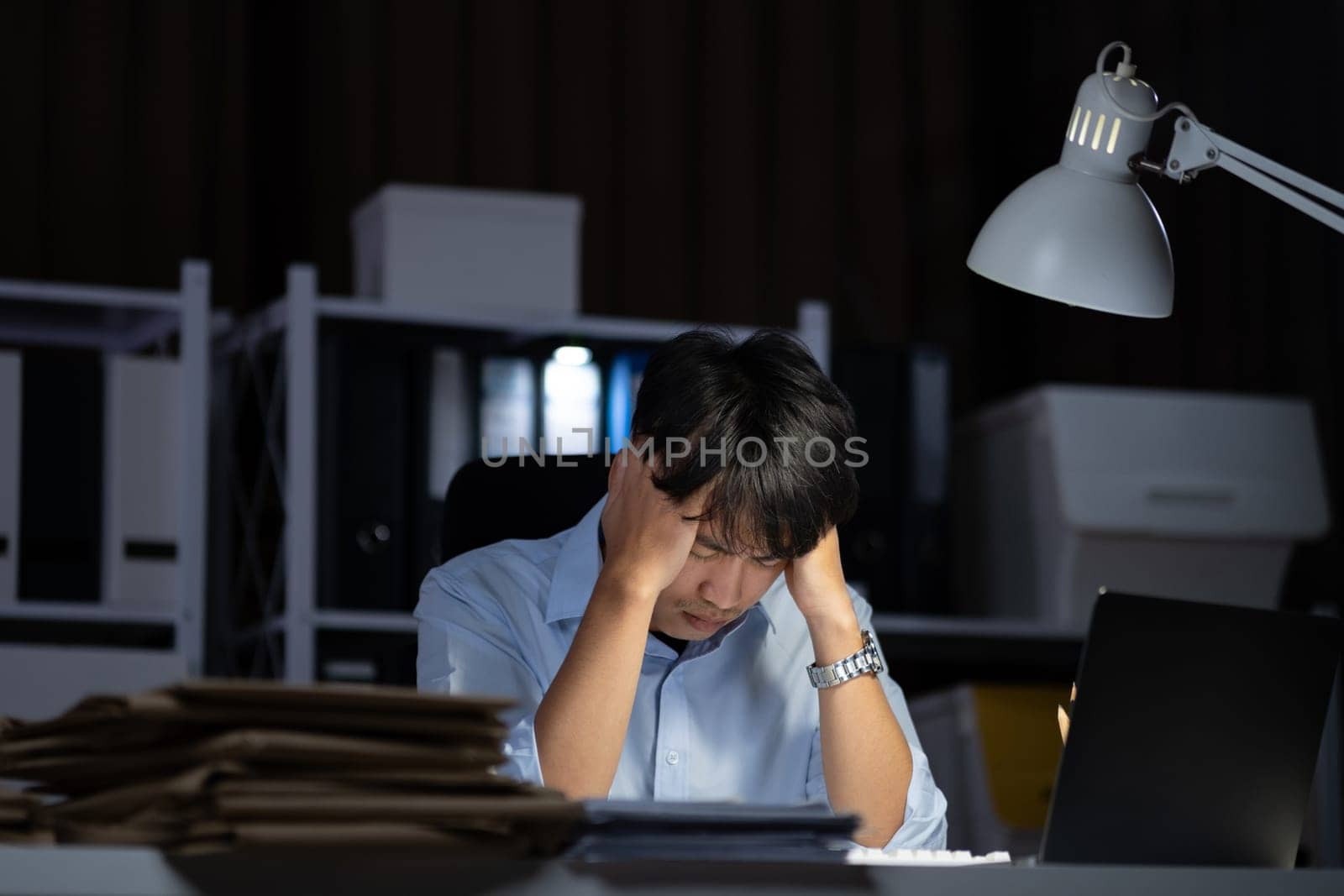 Businessman working overtime at his office He felt tired. by ijeab