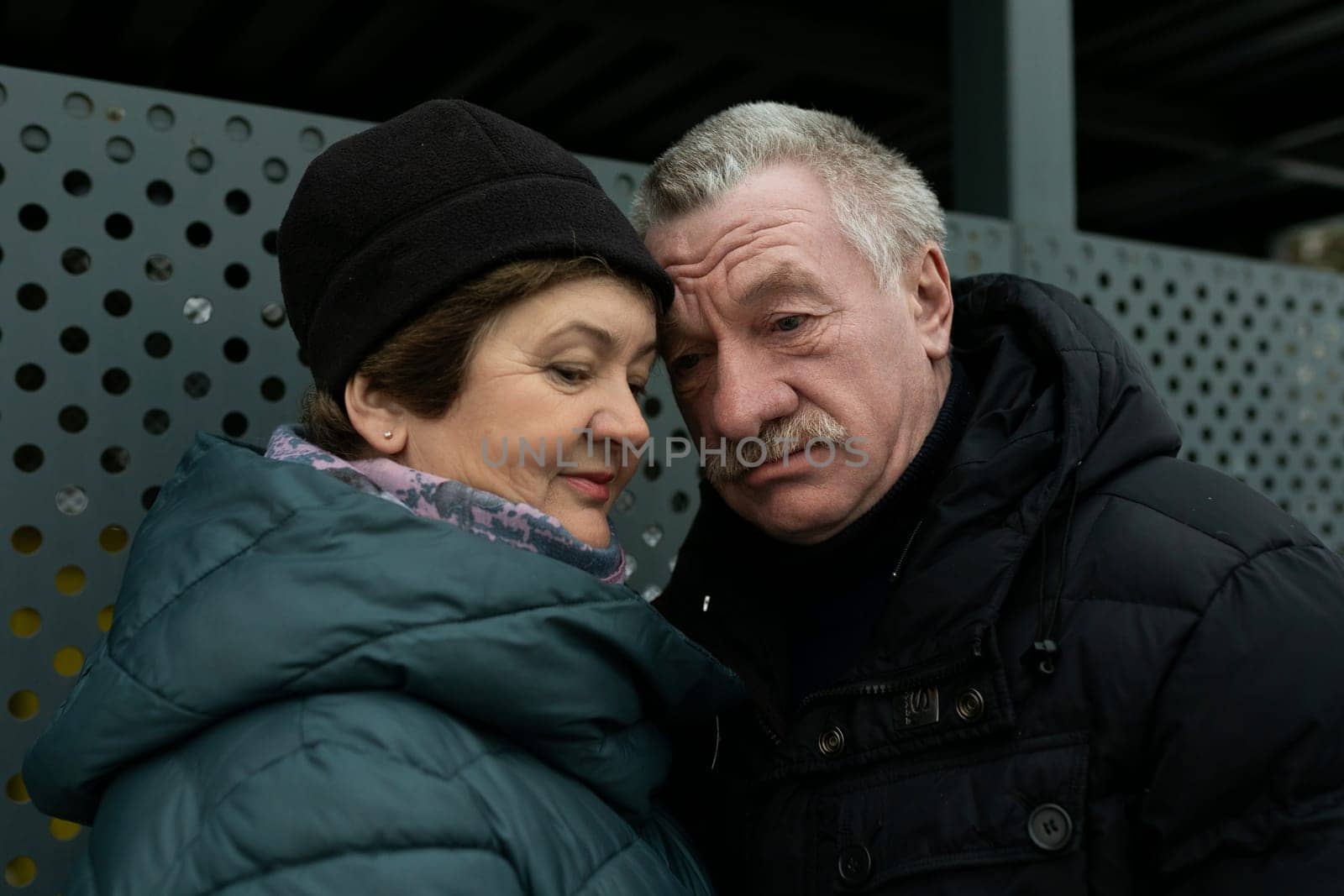 Cute mature couple talking to each other while looking down the street.