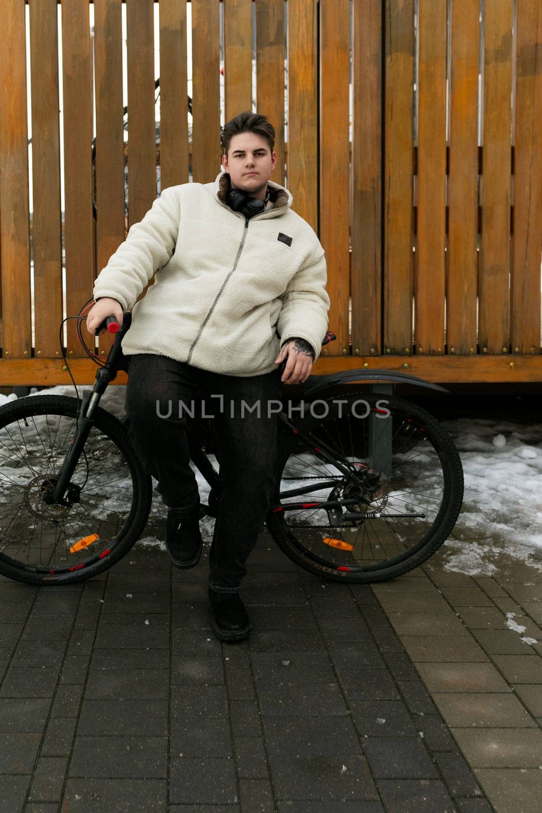 A handsome young guy rides around the city on a bicycle.