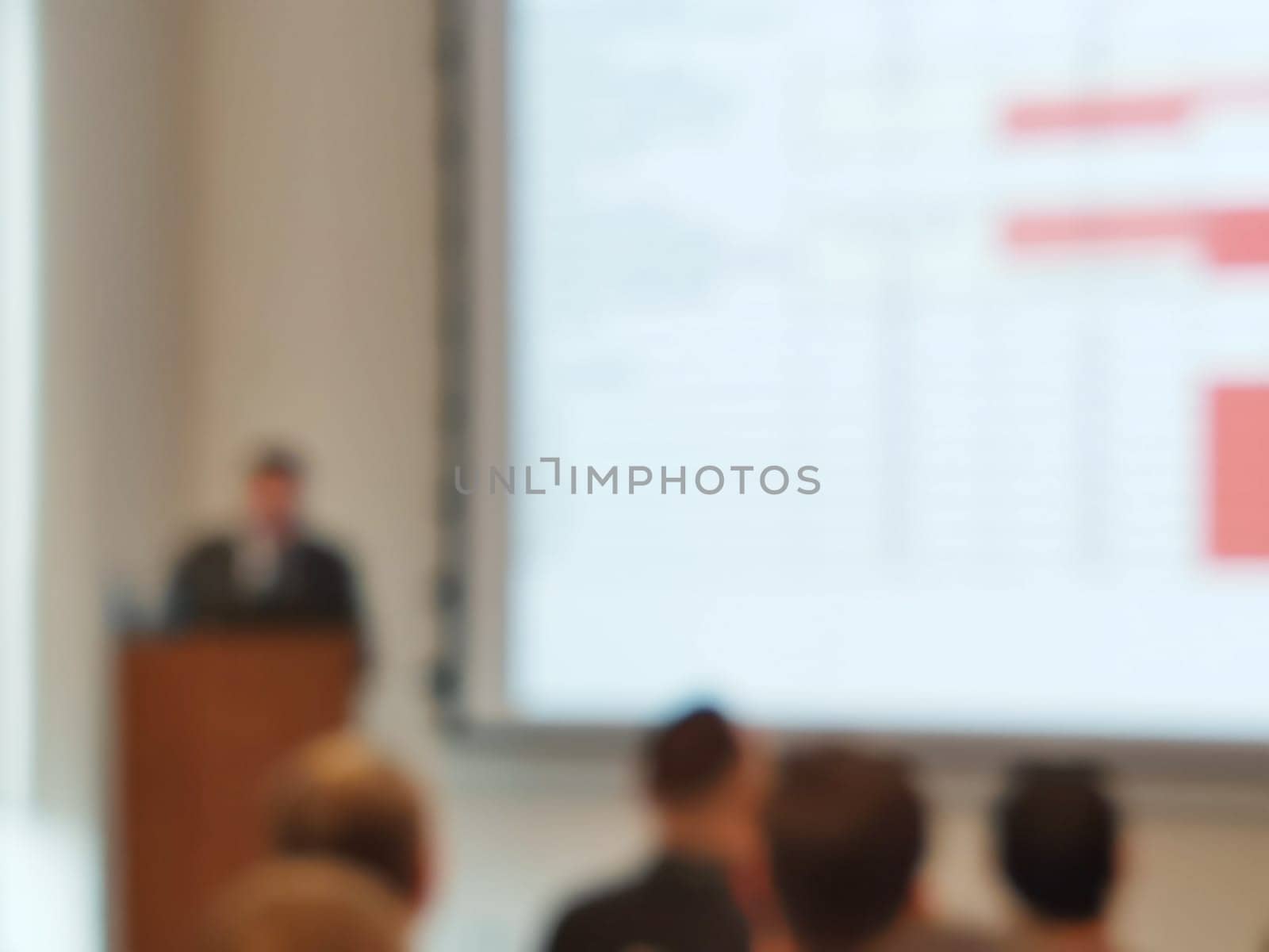 Blurred background image of audience in a business conference or seminar. Audience listens to the lecturer at the conference in auditorium.