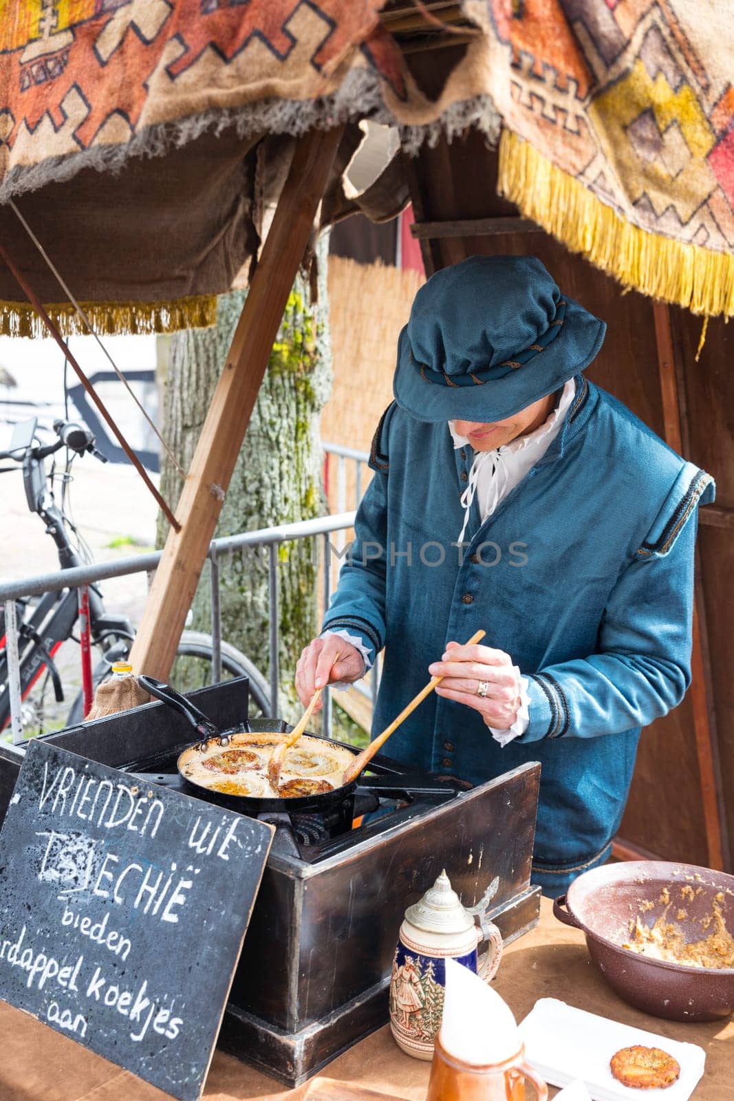 man making pancackes in traditional costume in den briel by compuinfoto