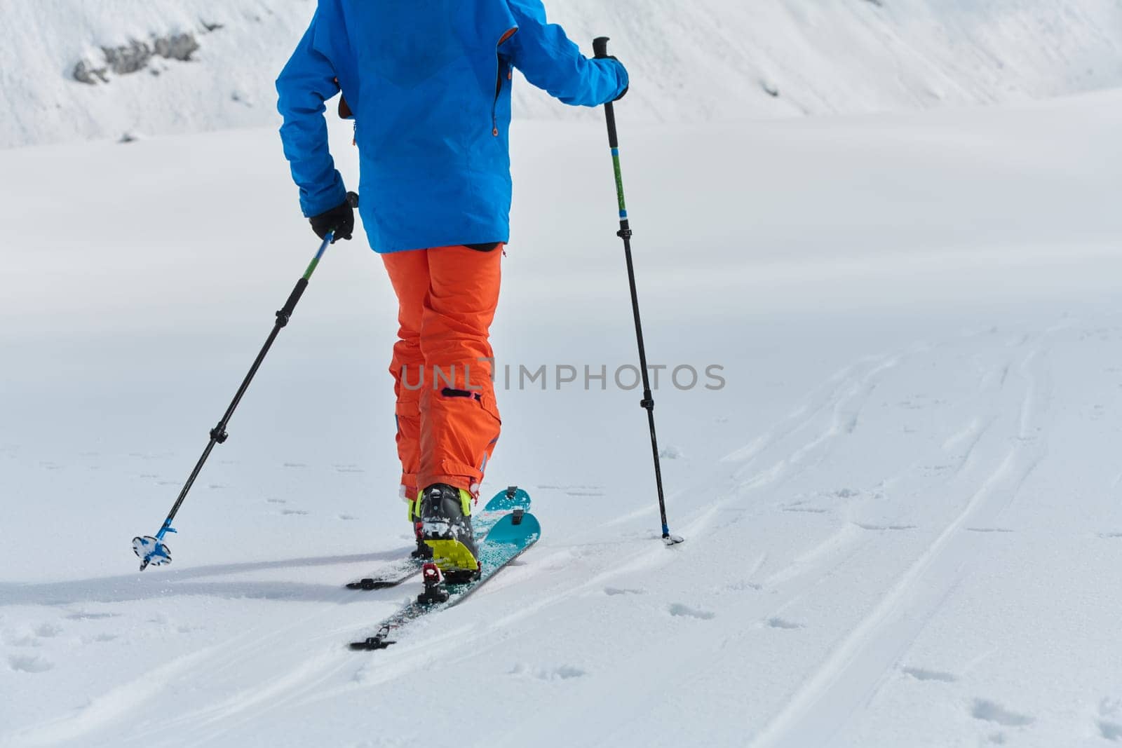 A Skier Scales a Treacherous Alpine Peak by dotshock