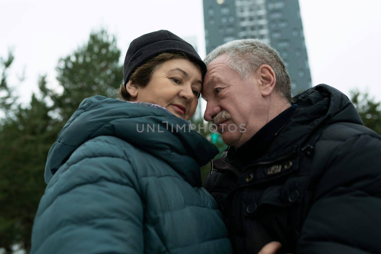 European mature family hugging each other while walking.