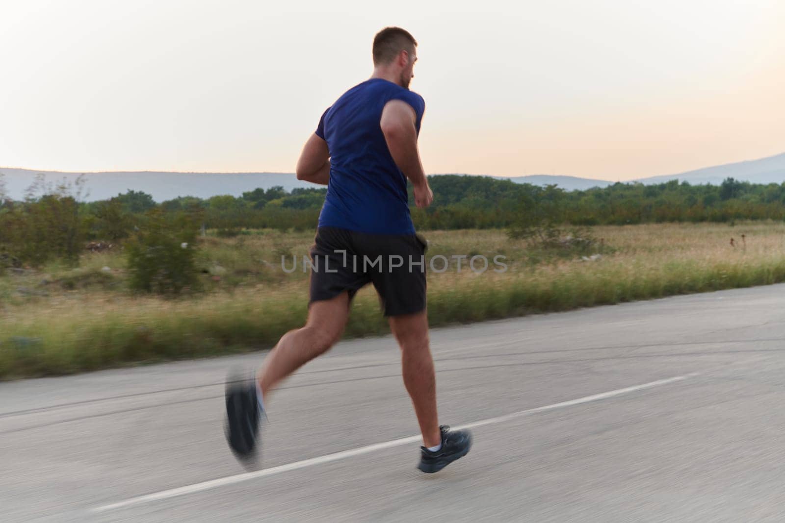 A highly motivated marathon runner displays unwavering determination as he trains relentlessly for his upcoming race, fueled by his burning desire to achieve his goals.