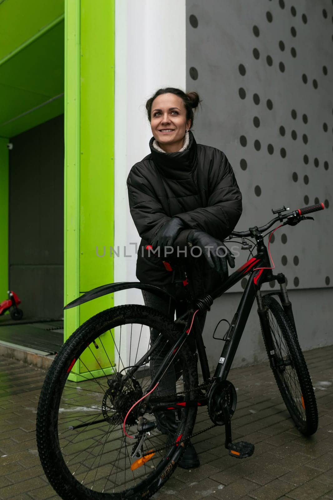 Young pretty woman riding a bicycle in winter.