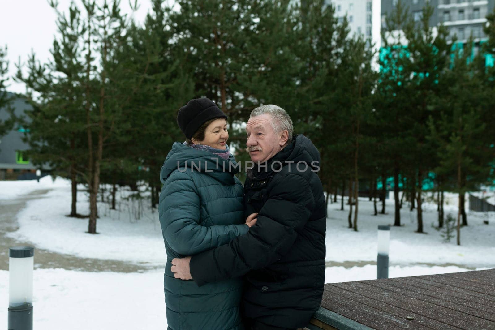 Happy elderly couple walking in the park and confessing their feelings.