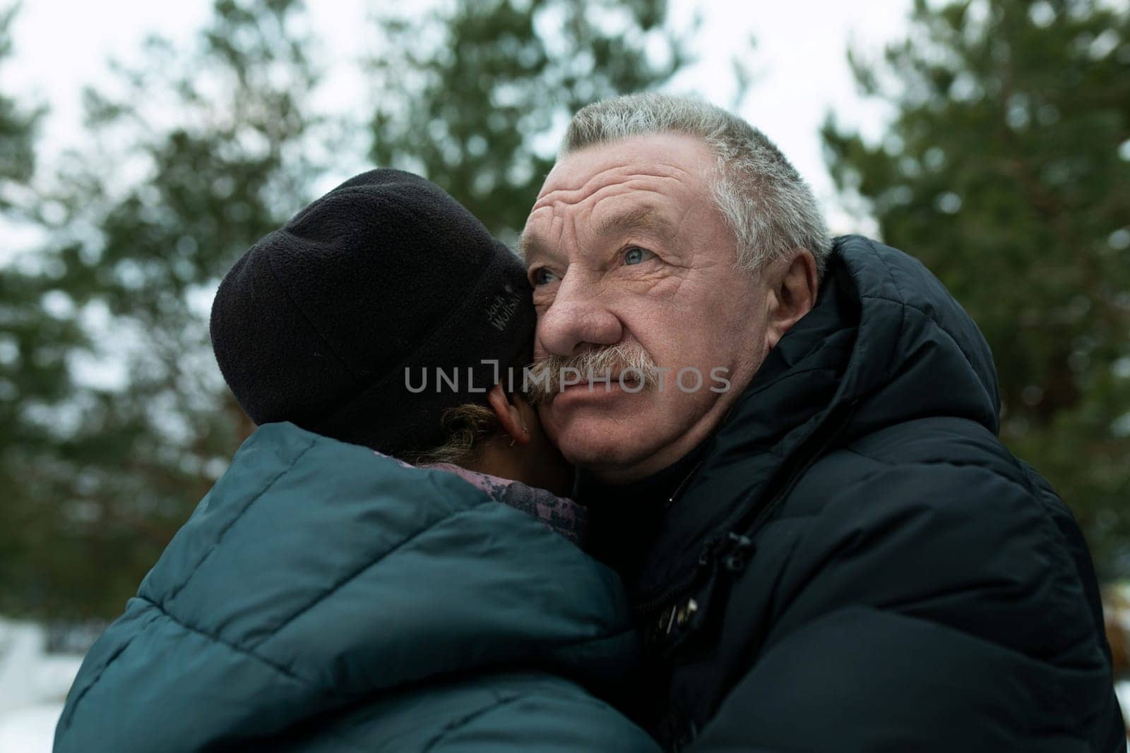 European mature family hugging each other while walking.