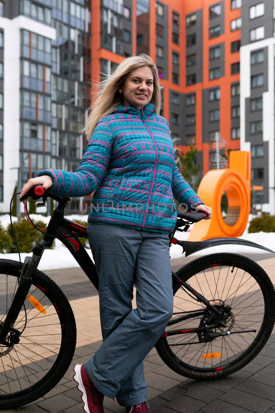 Athletic woman enjoys traveling around the city using a bicycle.