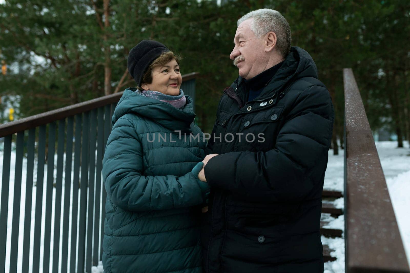 Cute mature couple went for a walk in the cold season of winter by TRMK